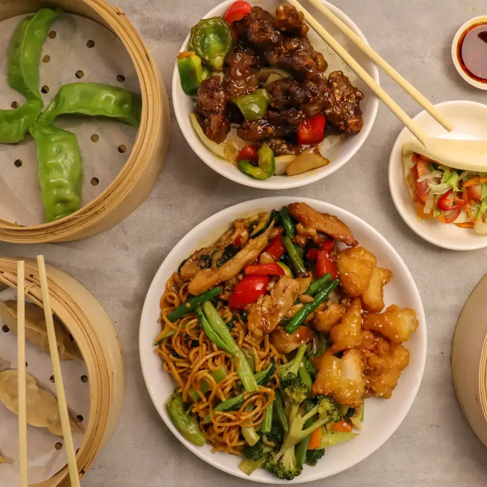 Bamboo steamers of dumplings, wok-fried plates and noodles from Mama Bao