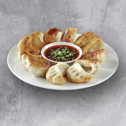 Pan-fried pork dumplings with chilli dipping sauce